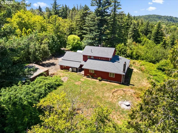 an aerial view of a house with a yard and garden