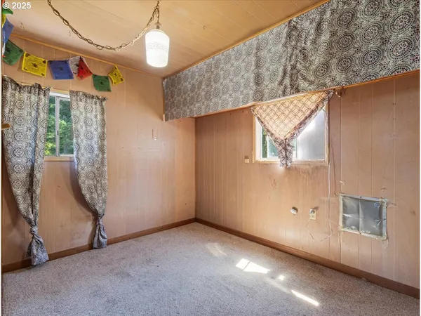 an empty room with windows and entrance