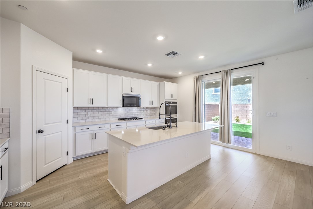 3782 Alla Rocca Avenue Henderson, NV 89044 - Photo 11 of 55 This bright kitchen features sleek appliances and ample counter space, perfect for culinary endeavors.