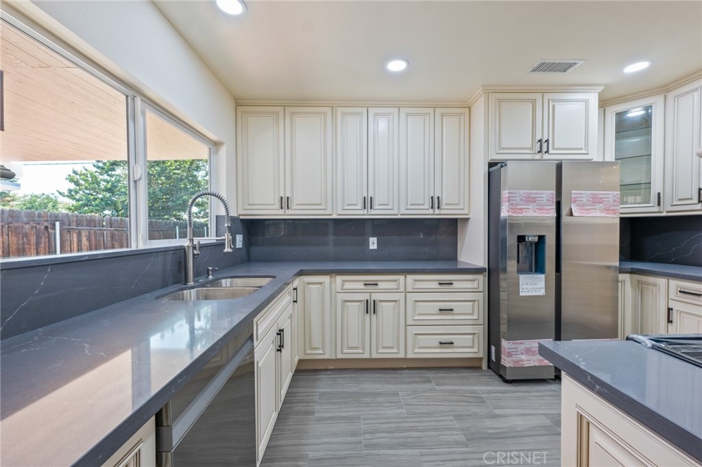 17604 Willard Street Northridge, CA 91325 - Photo 3 of 28 a kitchen with stainless steel appliances granite countertop a stove a sink and a refrigerator