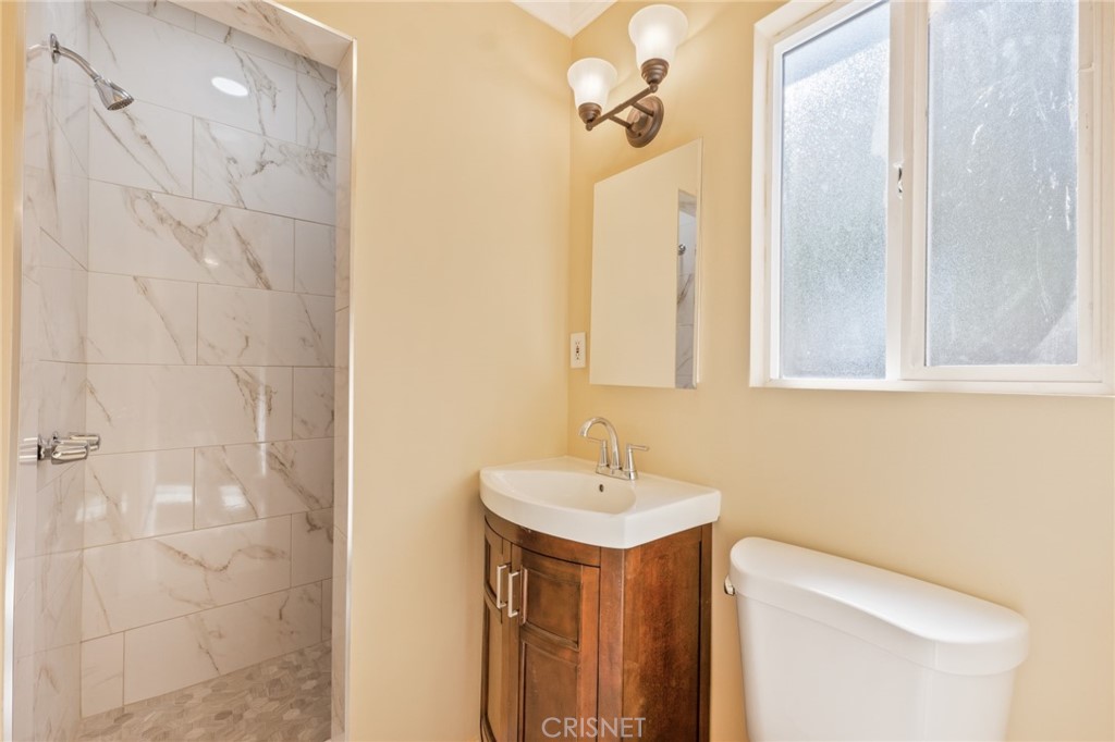 17604 Willard Street Northridge, CA 91325 - Photo 10 of 28 a bathroom with a sink a toilet and shower