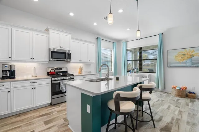 a living room with a couch and a view of kitchen