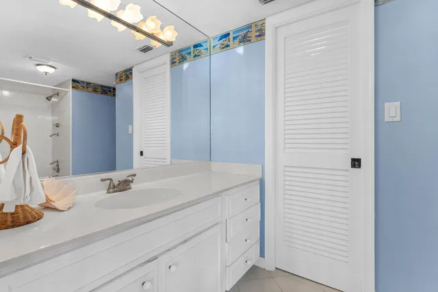 a bedroom with two beds and a chandelier