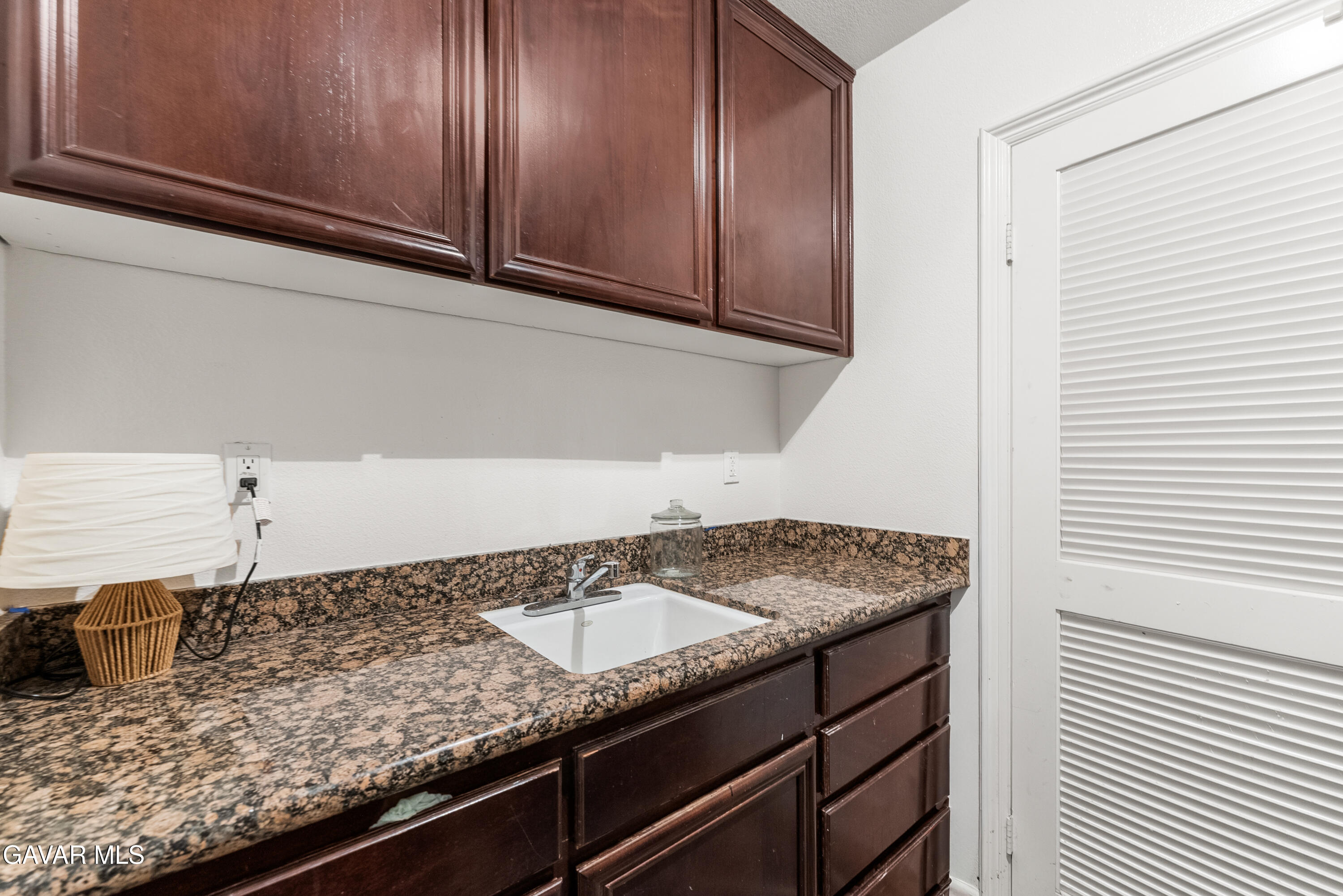 658 Lago Lindo Road Palmdale, CA 93550 - Photo 46 of 91 a kitchen with granite countertop stainless steel appliances sink and cabinets
