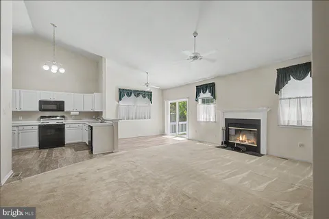 a view of kitchen with a fireplace a sink and a counter top space