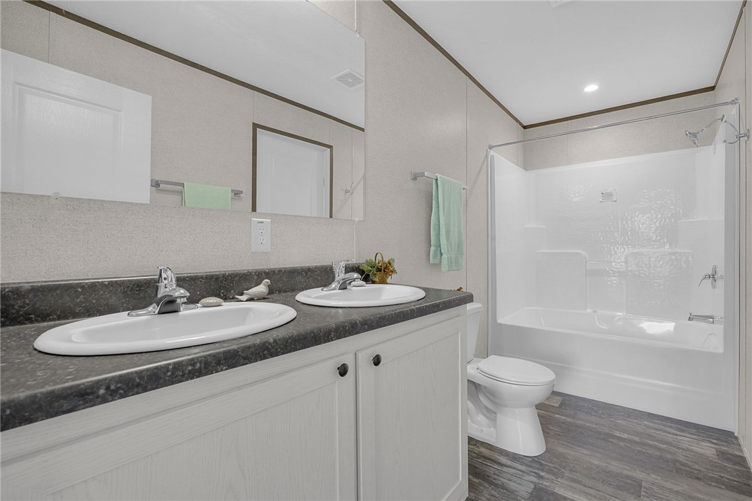 375 Griggs Road Six Mile, SC 29682 - Photo 19 of 36 This primary bathroom offers dual sinks and a shower-tub combination for comfort.