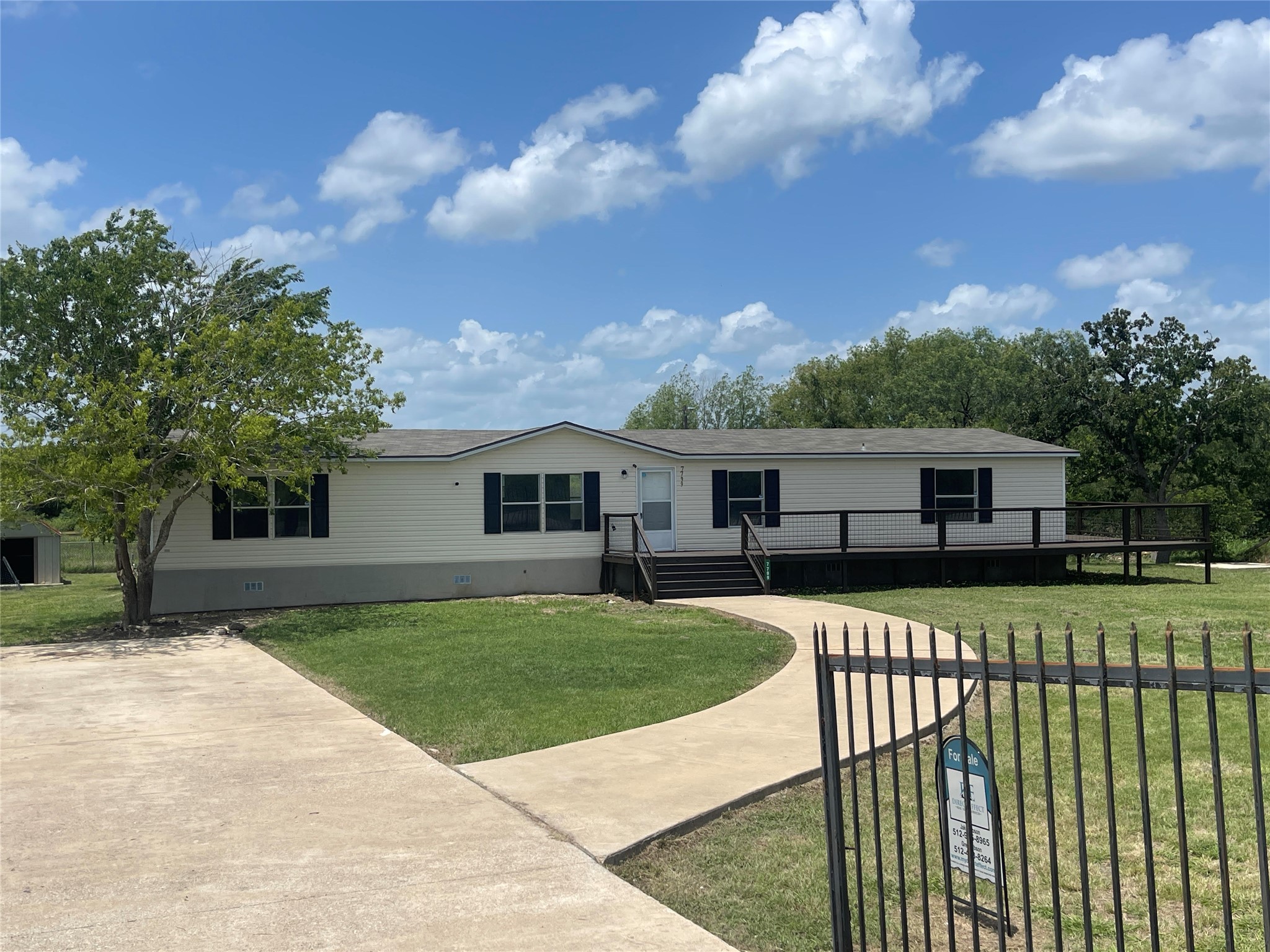 7799 Taylorsville Road Dale, TX 78616 - Photo 1 of 1 a front view of a house with garden