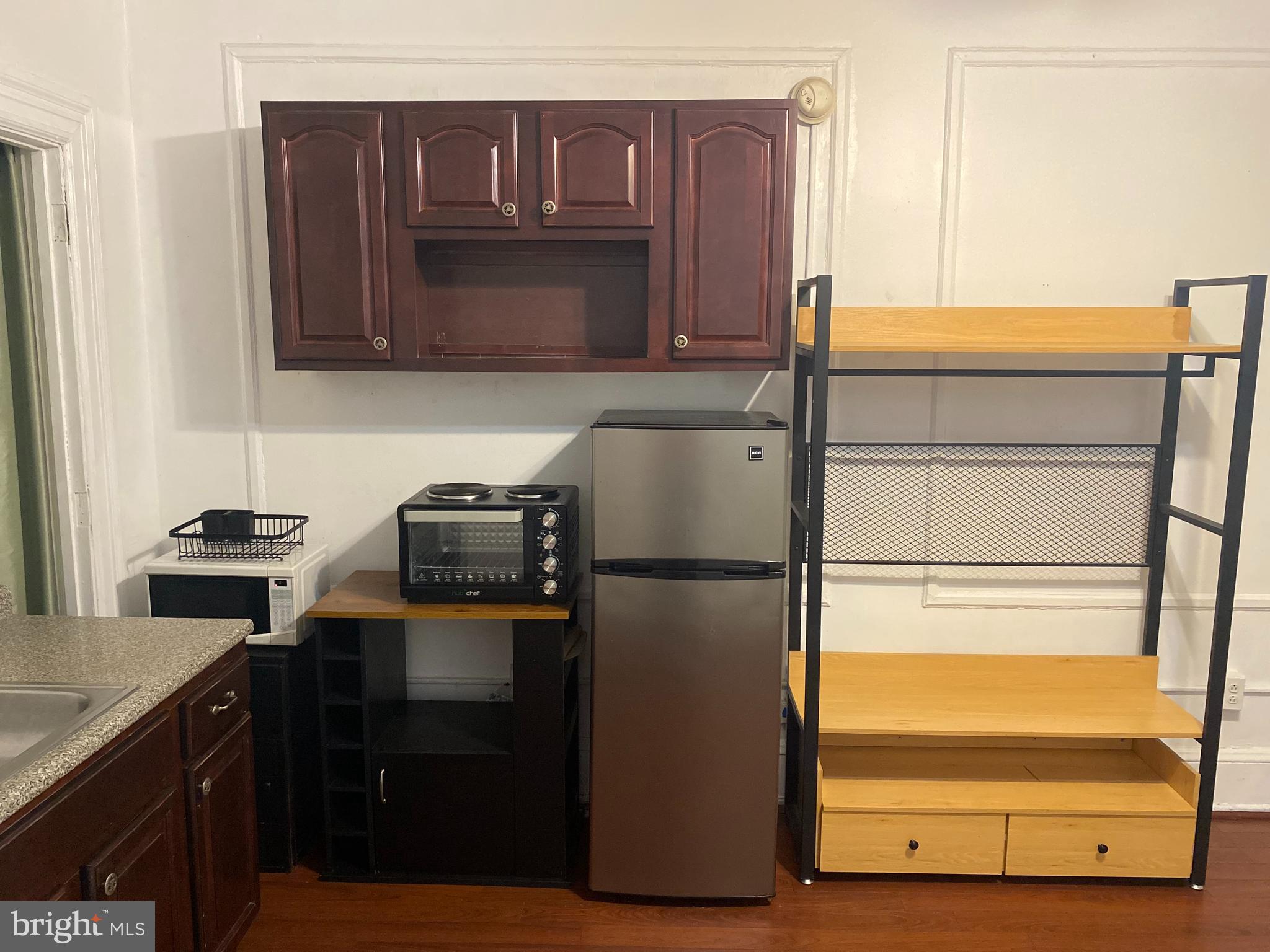 1324 Locust Street, Unit 308 Philadelphia, PA 19107 - Photo 5 of 11 a kitchen with stainless steel appliances a refrigerator and cabinets
