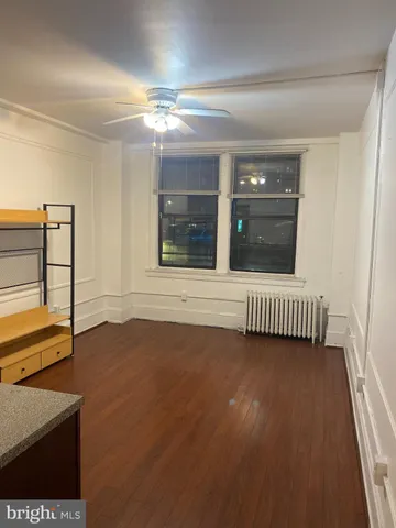 a view of a livingroom with wooden floor and window
