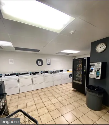 a kitchen with stainless steel appliances kitchen island granite countertop a refrigerator and stove