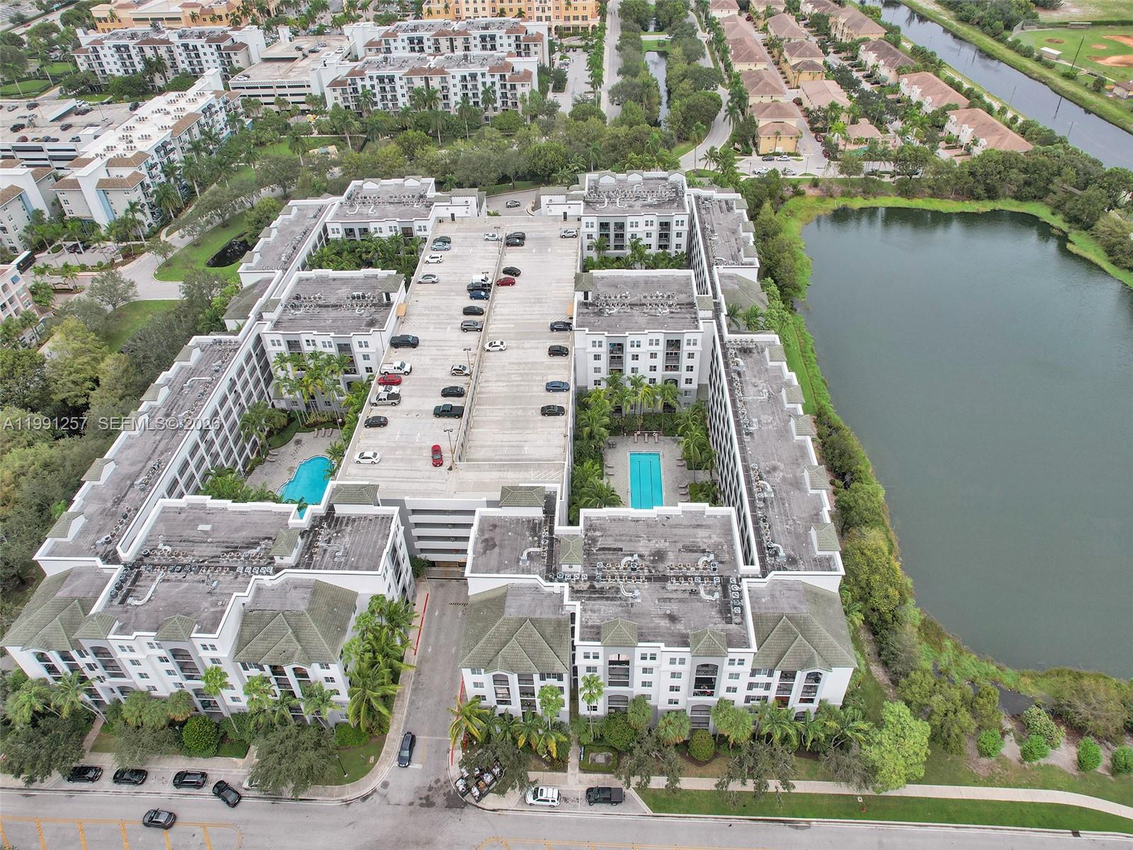 1660 Renaissance Commons Boulevard, Unit 2606 Boynton Beach, FL 33426 - Photo 21 of 26 an aerial view of a house with outdoor space and lake view
