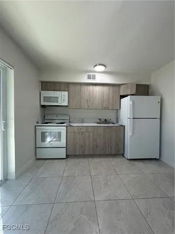 a kitchen with a cabinets and white stainless steel appliances