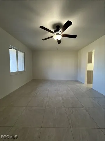 a view of an empty room with a ceiling fan