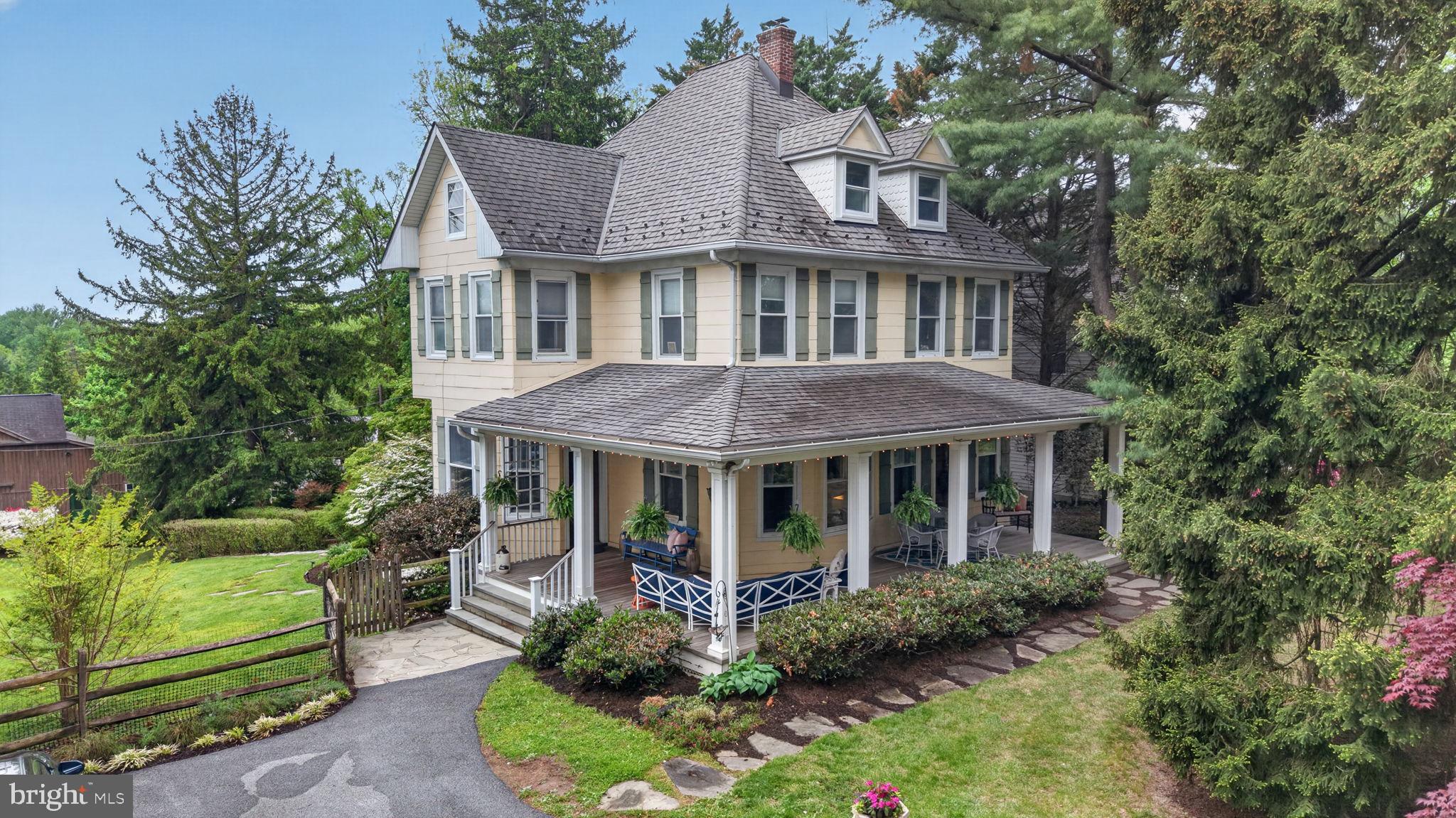 Charming Victorian home with lush greenery.
