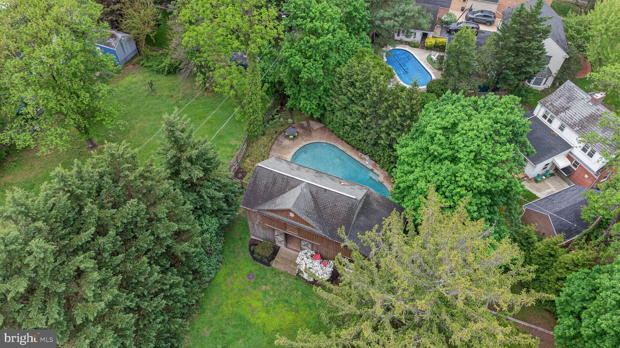 605 West Joppa Road Towson, MD 21204 - Photo 5 of 98 Lush greenery surrounds a serene pool.