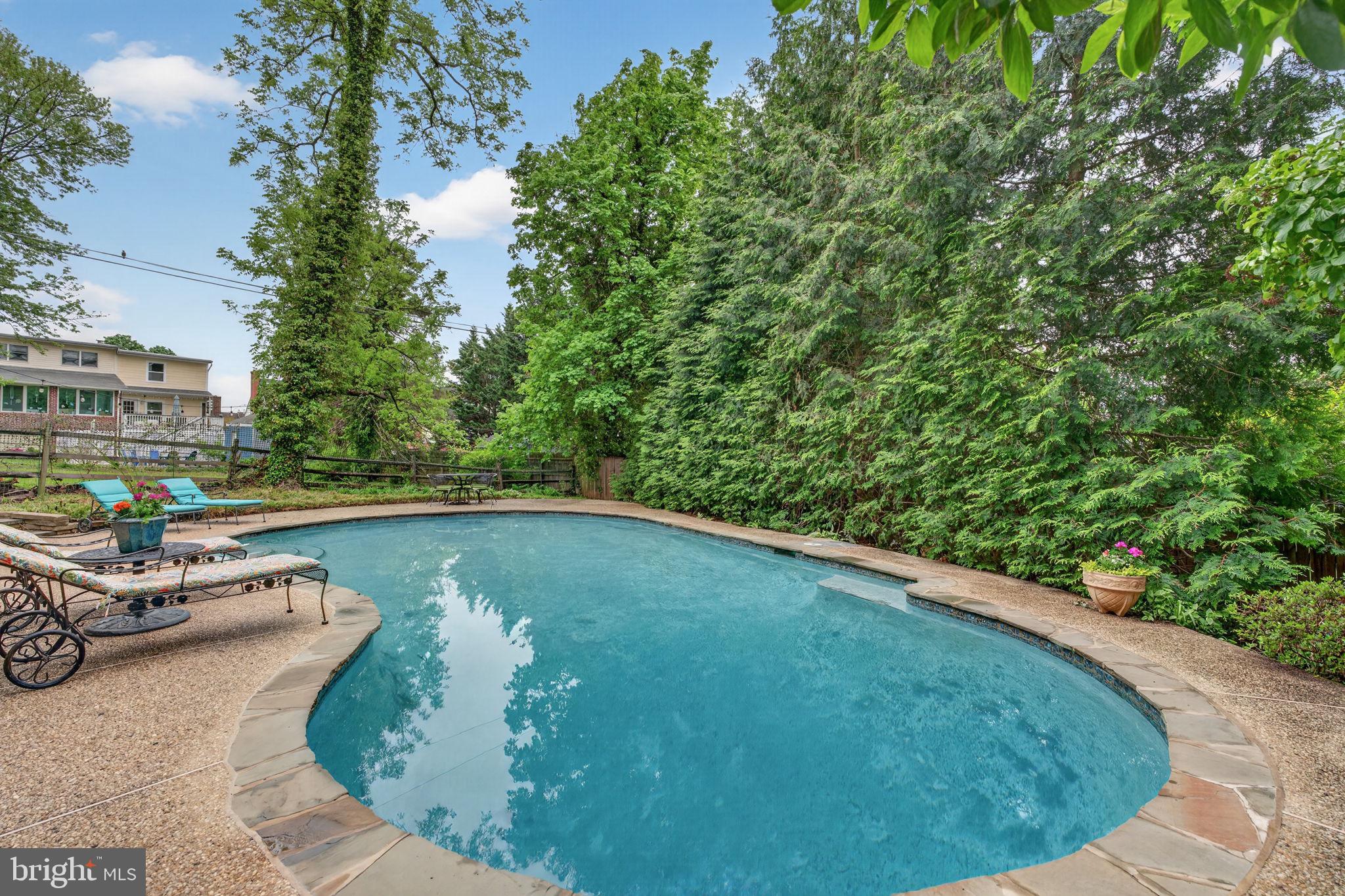 605 West Joppa Road Towson, MD 21204 - Photo 73 of 98 Serene poolside oasis in lush greenery.