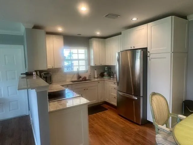 a kitchen with a refrigerator a sink and cabinets