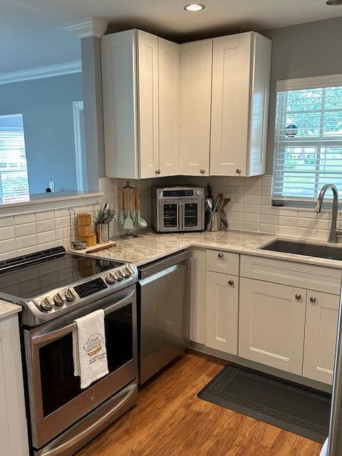 4585 Northwest 3rd Street, Unit D Delray Beach, FL 33445 - Photo 15 of 42 a kitchen with a stove white cabinets and a sink