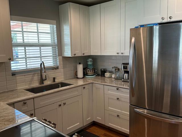 4585 Northwest 3rd Street, Unit D Delray Beach, FL 33445 - Photo 18 of 42 a kitchen with white cabinets and a refrigerator