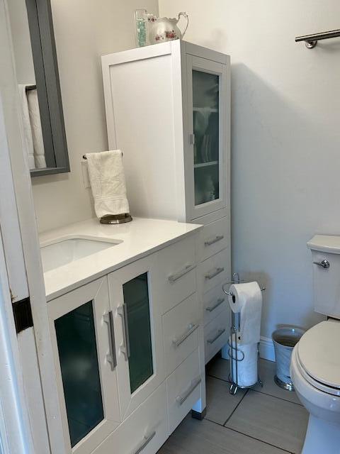 4585 Northwest 3rd Street, Unit D Delray Beach, FL 33445 - Photo 23 of 42 a bathroom with a sink toilet and mirror