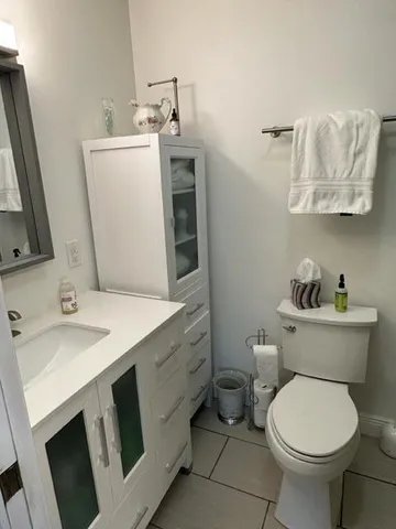 a bathroom with a sink toilet and mirror