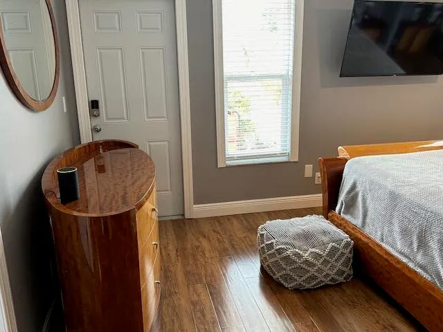 a bedroom with a bed and a mirror