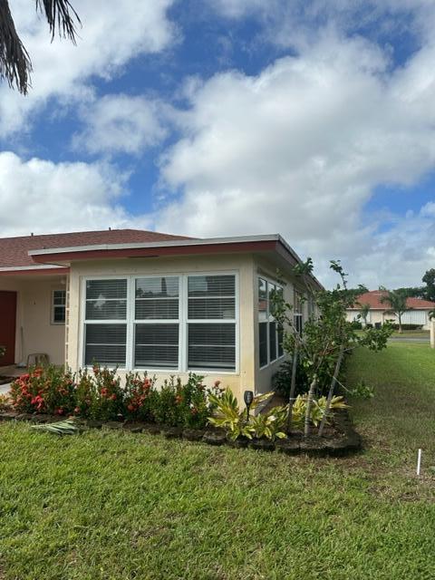 4585 Northwest 3rd Street, Unit D Delray Beach, FL 33445 - Photo 3 of 42 a front view of a house with garden