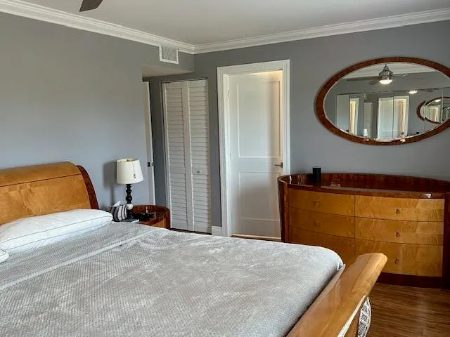 a bedroom with a bed and a mirror