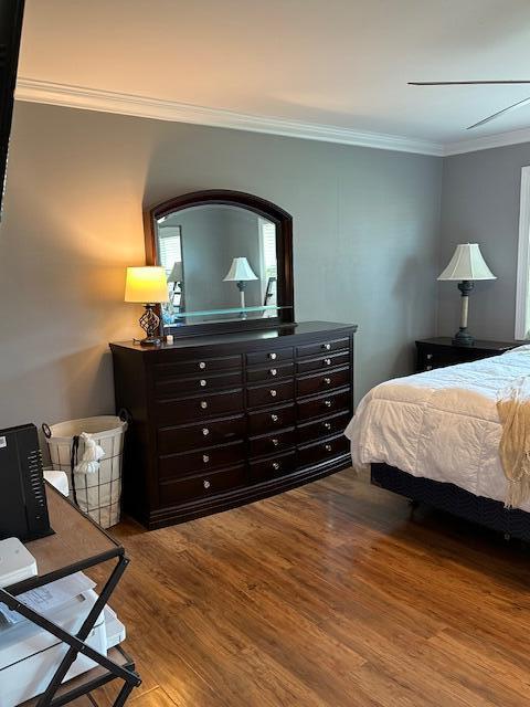 4585 Northwest 3rd Street, Unit D Delray Beach, FL 33445 - Photo 36 of 42 a bedroom with a bed and wooden floor