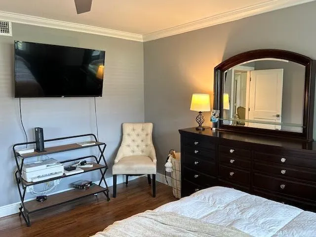 a living room with a flat screen tv and a dresser