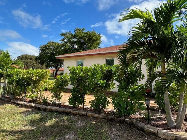4585 Northwest 3rd Street, Unit D Delray Beach, FL 33445 - Photo 41 of 42 a view of a house with a yard