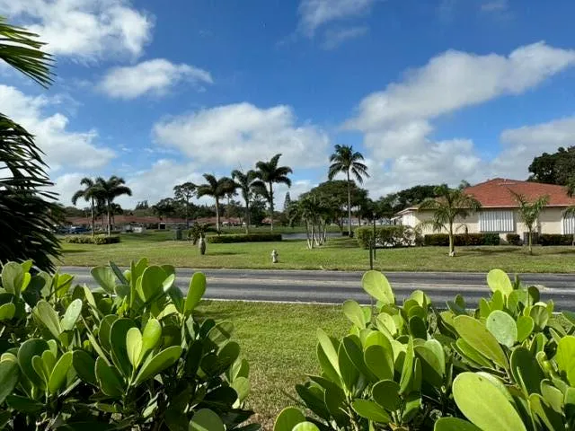 a view of yard with swimming pool and green space