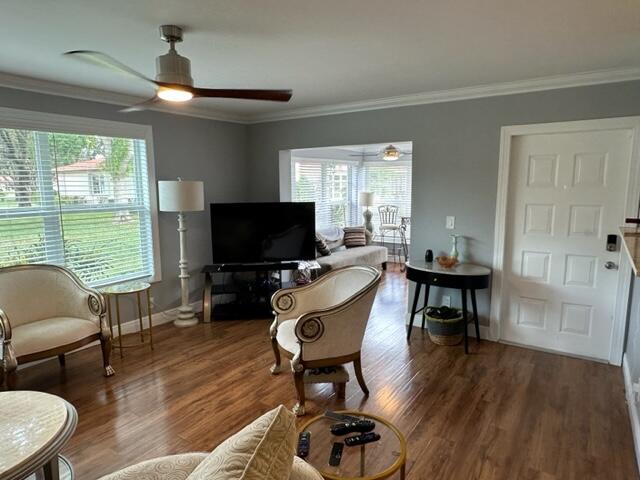 4585 Northwest 3rd Street, Unit D Delray Beach, FL 33445 - Photo 9 of 42 a living room with furniture a flat screen tv and a large window