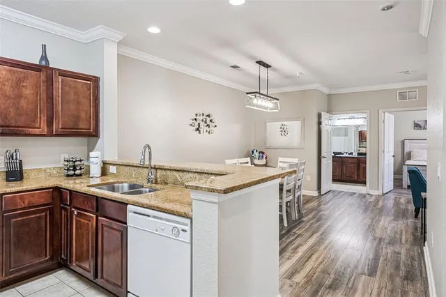 a kitchen with stainless steel appliances lots of counter space and a sink