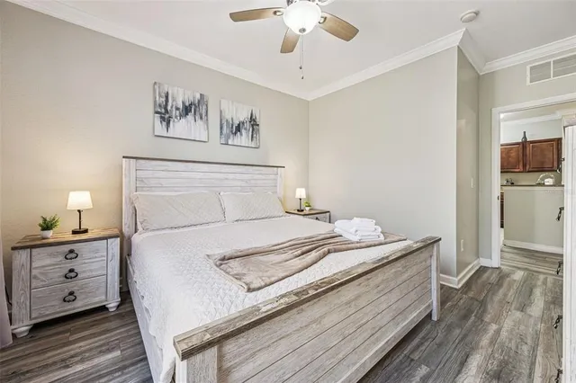 a bedroom with a large bed and a window