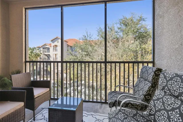 an aerial view of a city with lots of residential buildings ocean and mountain view in back
