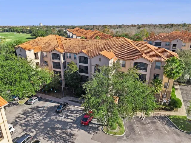 an aerial view of residential building and lake