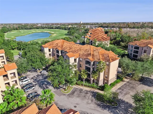 an aerial view of residential building and lake