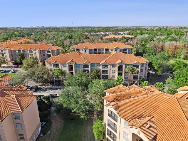 an aerial view of a house with a garden and swimming pool