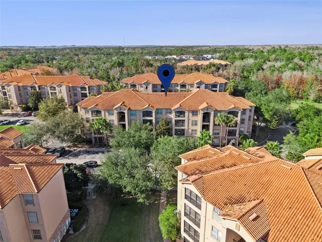 an aerial view of multiple houses with yard