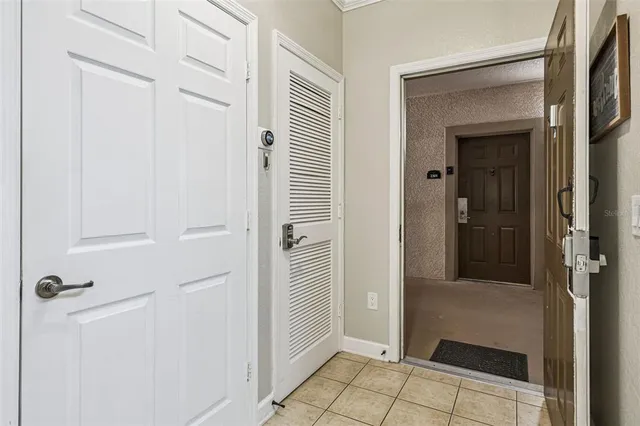 a living room with furniture a large window and a chandelier