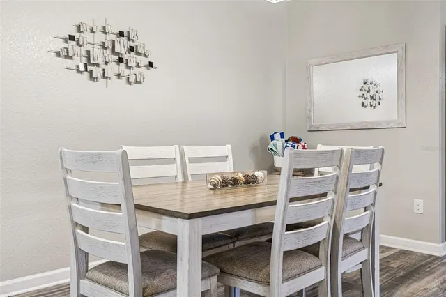 a view of a dining room with furniture and wooden floor