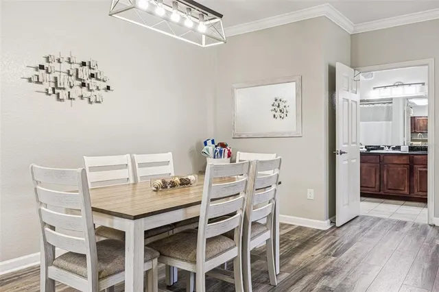 a view of a dining room with furniture wooden floor and a chandelier