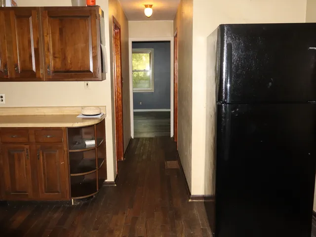 a kitchen with stainless steel appliances granite countertop a refrigerator and a stove