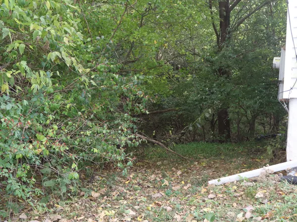 a kitchen with stainless steel appliances granite countertop a sink a stove a refrigerator and island with wooden floor