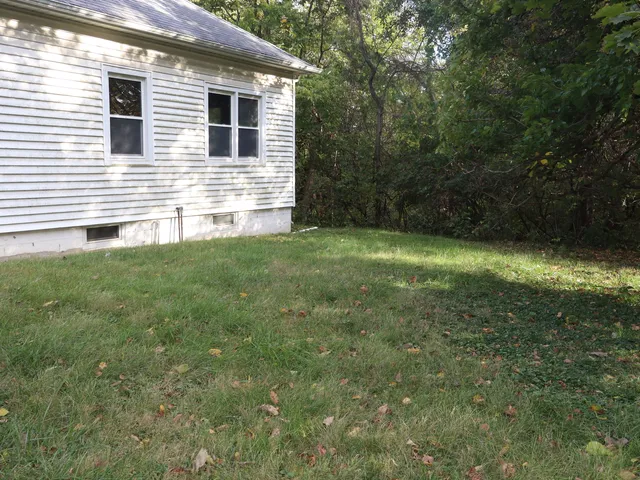a view of a backyard of the house