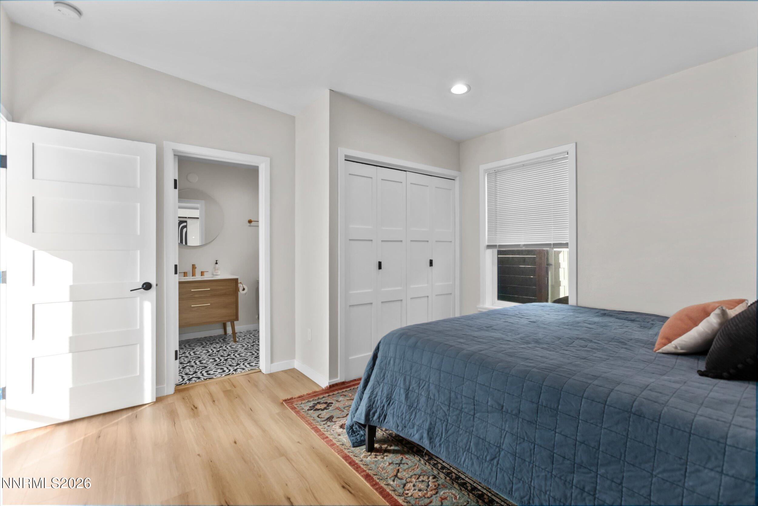 536 Sinclair Street Reno, NV 89501 - Photo 13 of 24 a bedroom with a large bed and a chandelier