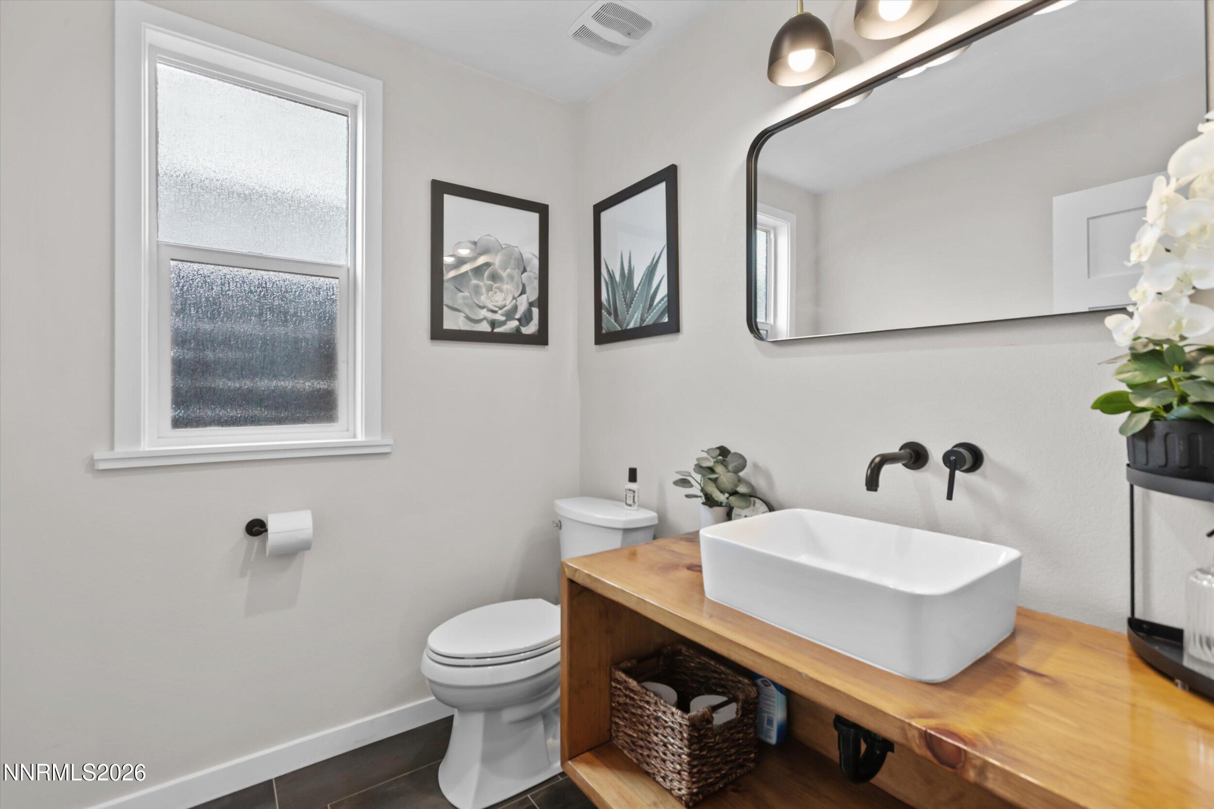 536 Sinclair Street Reno, NV 89501 - Photo 15 of 24 a bathroom with a sink toilet and mirror