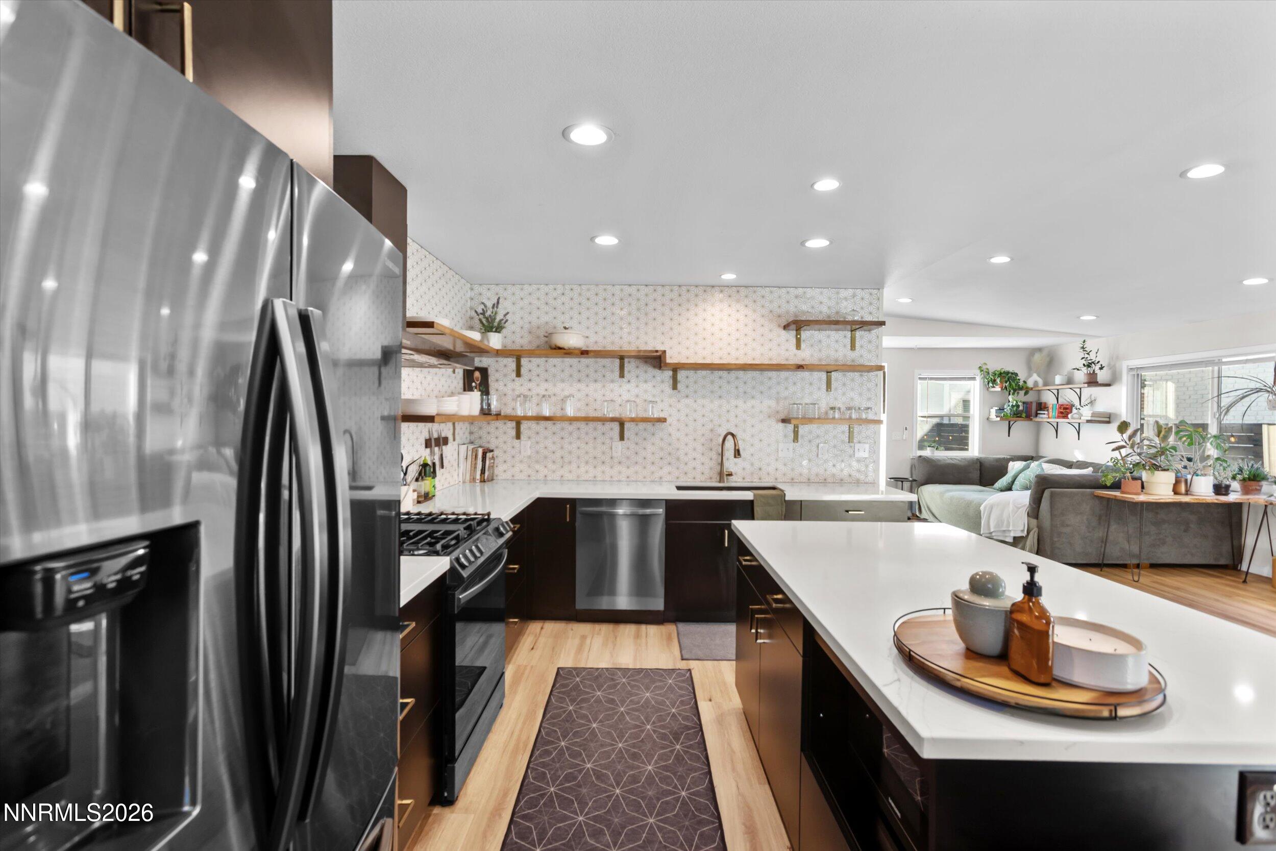 536 Sinclair Street Reno, NV 89501 - Photo 5 of 24 a kitchen with stainless steel appliances granite countertop a sink a stove and a refrigerator