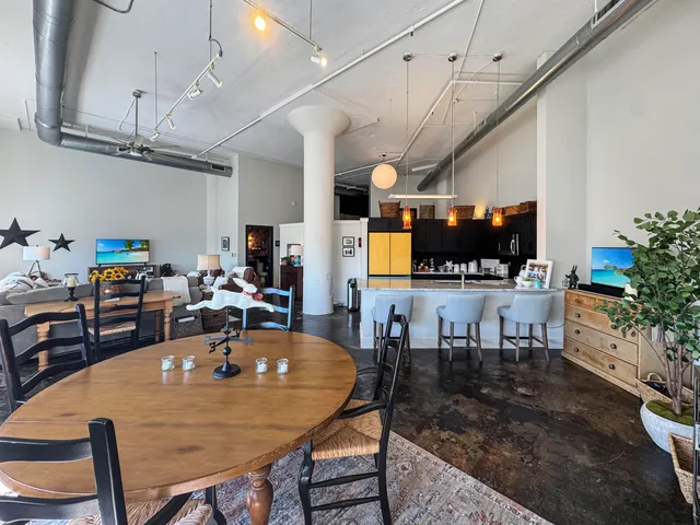 a view of a dining room with furniture and a window